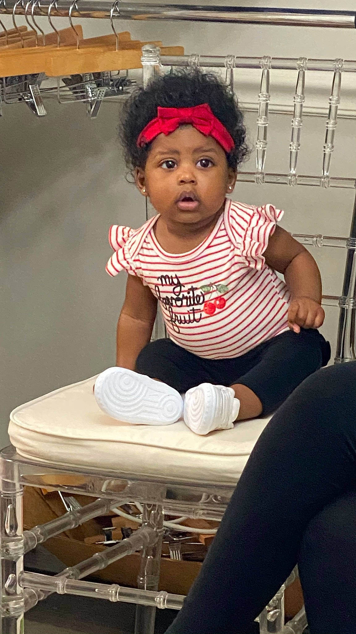 Carlee is registered to the contest to win money with this photo: active_pants, ankle, baby, baby_toddler_clothing, balance, child, child_model, comfort, foot, hair_accessory, headband, headpiece, headwear, human_leg, knee, lap, person, sneakers, sock, thigh