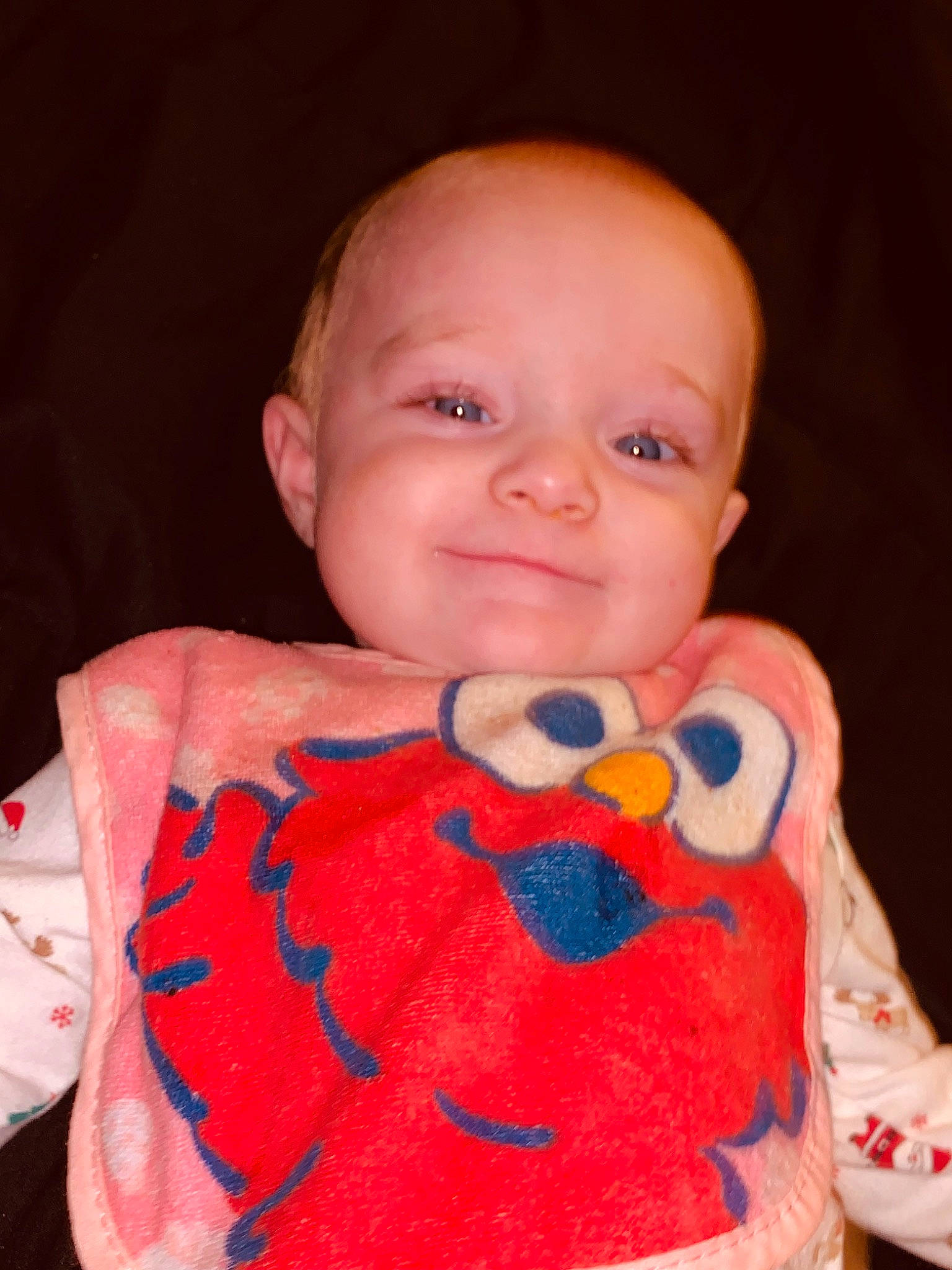 Violet is registered to the contest to win money with this photo: baby, baby_products, baby_toddler_clothing, baby_toys, carmine, cheek, child, finger, happy, joy, linens, lip, nose, pattern, person, pink, play, skin, sleeve, smile