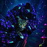 cat, kitten, animal, pet, feline, striped_fur, green_eyes, wide_eyed, sitting, blanket, fabric, chair, outdoor, night, neon_lighting, blue_light, purple_light, glowing_mushroom, mystical, portrait
