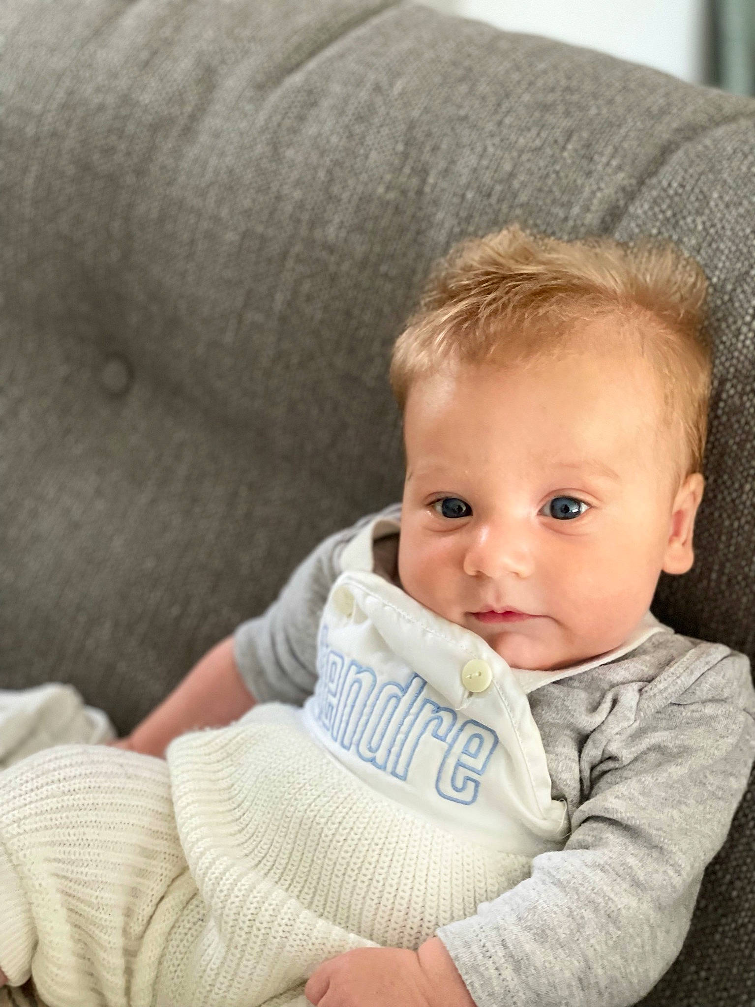 June participe au concours pour gagner de l'argent avec cette photo : baby, baby_toddler_clothing, cheek, child, comfort, couch, fur, happy, linens, nose, person, room, sitting, skin, sleeve, textile, toddler, white, wood