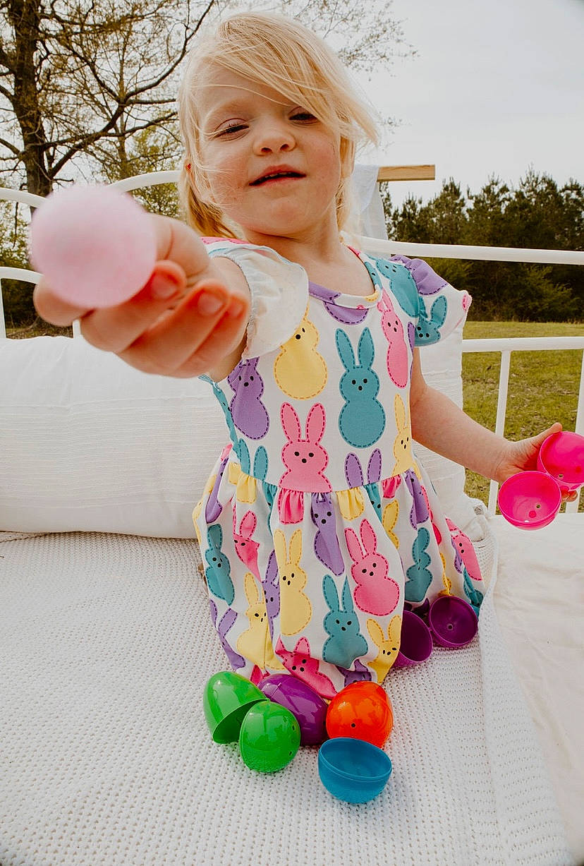 Adaleigh is registered to the contest to win money with this photo: arm, baby, baby_toddler_clothing, child, dress, face, facial_expression, finger, fun, gesture, grass, hand, happy, leg, leisure, person, pink, public_space, sleeve, summer