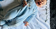 Makai joined the competition — help win amazing prizes! baby, infant, blue_onesie, blanket, numbers, deer_antlers, smiling, laughing, lying_down, cozy, soft_texture, play_mat, child, cute, happy, indoor, infant_clothing, person, head, pale_skin