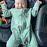 Makai is registered to the contest to win money with this photo: baby, child, smiling, green_onesie, animal_print, car_seat, joyful, face, infant, cute, happy, clothing, sitting, raised_arms, indoor, person, portrait, baby_girl, baby_boy, playful