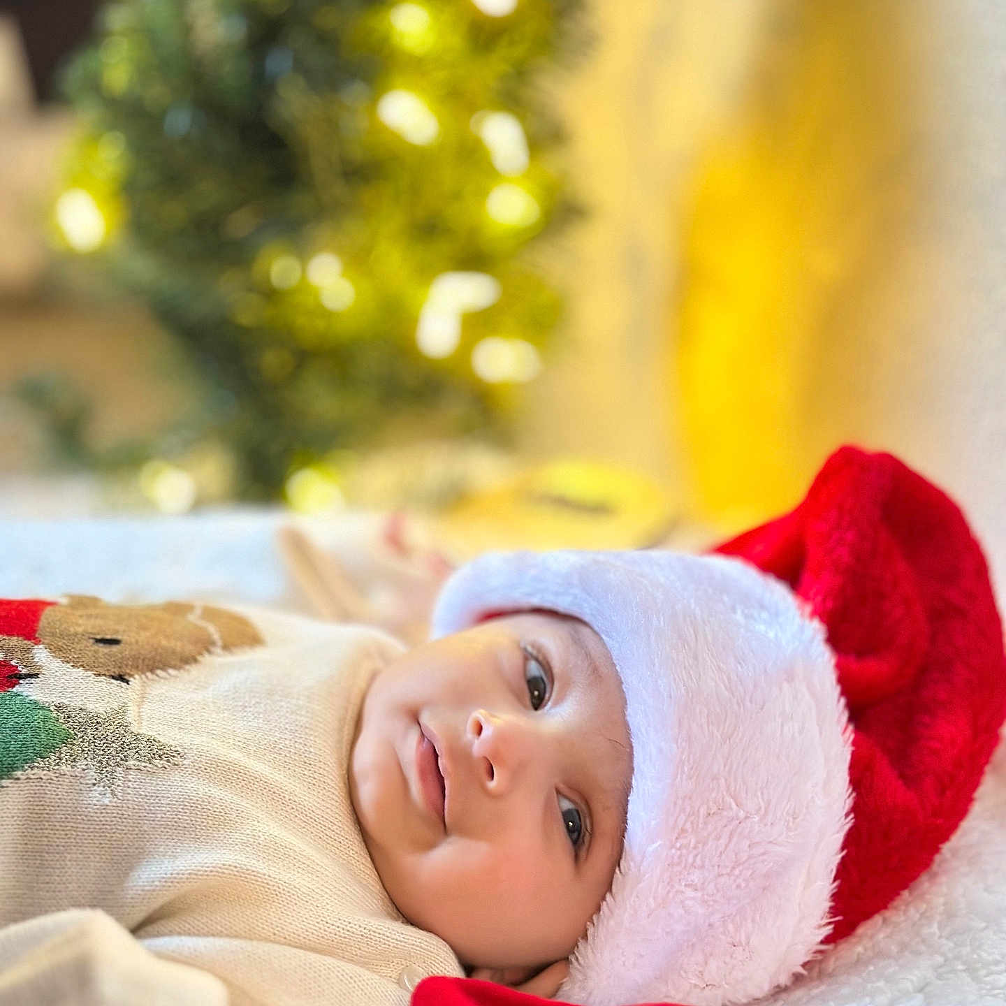 Agastya joined the competition — help win amazing prizes! baby, blurred_background, celebration, child, christmas, cozy, cute, festive, happy, holiday, holiday_decor, indoors, infant, lying_down, portrait, santa_hat, smile, soft_blanket, sweater, warm_lighting