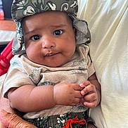 Jayden joined the competition — help win amazing prizes! baby, infant, child, portrait, smiling, indoors, hat, sun_hat, patterned_clothing, matching_outfit, sitting, being_held, adult, bottles, baby_bottle, hands, face, eyes, family, closeup
