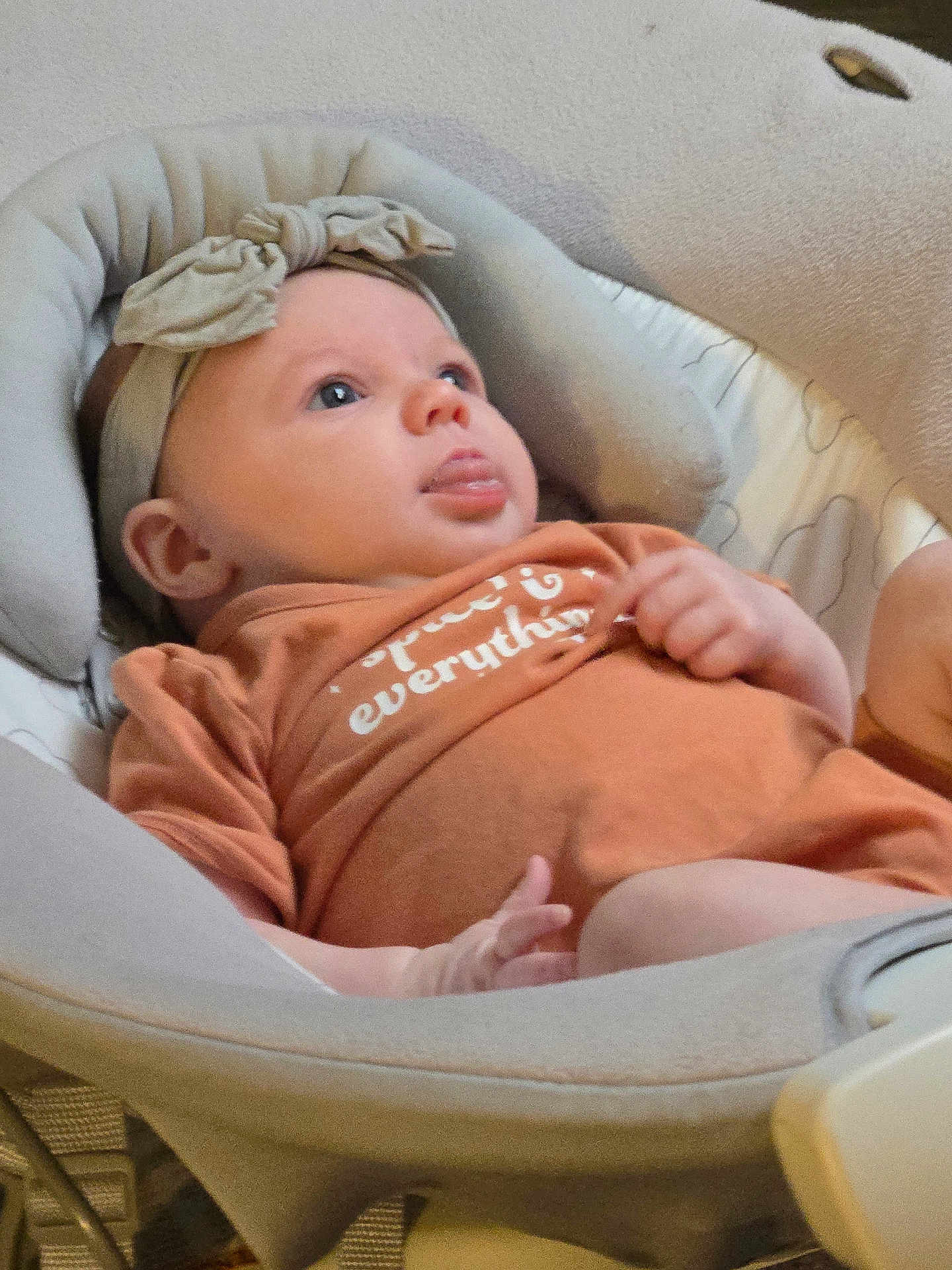 Xalia joined the competition — help win amazing prizes! baby, infant, headband, bow, baby_seat, orange_clothing, cushion, face, skin, hand, tongue, indoors, person, child, cute, looking_up, soft_fabric, relaxing, comfortable, closeup