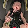 baby, sleeping, car_seat, pacifier, black_bow, infant, child, clothing, hand, money, safety_harness, cute, face, resting, indoors, person, young_child, seat, skin, nap