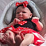baby, infant, child, headband, bow, polka_dot, red, black_clothing, baby_seat, cushion, feet, hands, face, indoor, portrait, cute, fashion, expression, young_child, clothing