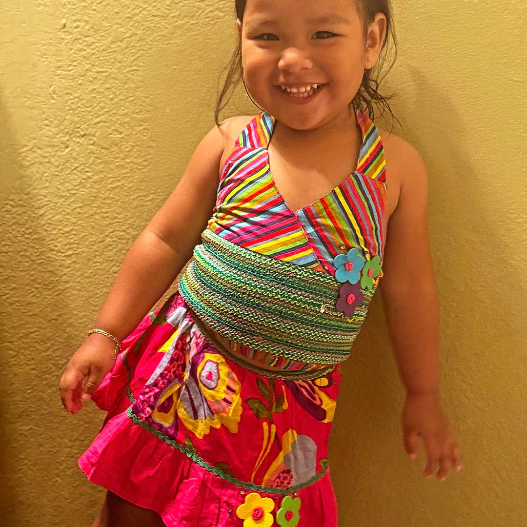 Keyianah Star joined the competition — help win amazing prizes! bracelet, child, colorful_dress, cute, fashion, floral_pattern, girl, hair_tie, happy, indoor, playful, portrait, posing, smile, sneakers, standing, striped, white_shoes, yellow_wall, young