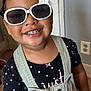 Keyianah Star joined the competition — help win amazing prizes! toddler, child, smiling, sunglasses, white_sunglasses, polka_dot, overalls, indoor, face, happy, cute, fashion, portrait, person, young_child, accessory, hand, hair, black_shirt, bracelet