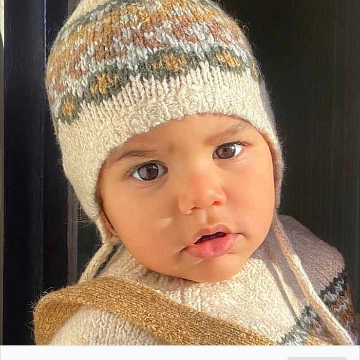 Rayan is registered to the contest to win money with this photo: baby, baseballcap, beanie, bonnet, cap, clothing, face, glove, hat, head, knitting, newborn, person, photography, portrait, text