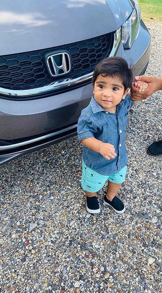 Bryan is registered to the contest to win money with this photo: automotive_design, automotive_exterior, automotive_fog_light, automotive_lighting, automotive_tire, black, bumper, car, grille, headlamp, hood, motor_vehicle, person, personal_luxury_car, photograph, rim, tire, toddler, vehicle, vehicle_door