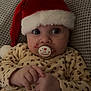 Naya participe au concours pour gagner de l'argent avec cette photo : baby, child, christmas, couch, cozy, cute, expression, face, hands, holiday, indoors, infant, leopard_print, onesie, pacifier, person, santa_hat, soft_texture, warm_clothing, wide_eyes