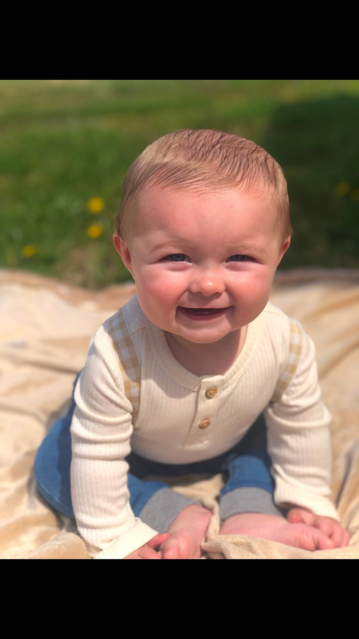 Noah is registered to the contest to win money with this photo: baby, baby_toddler_clothing, cheek, chin, clothing, eye, grass, happy, head, human_body, iris, joy, lip, mouth, nose, people_in_nature, person, plant, skin, sleeve
