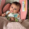 Rose joined the competition — help win amazing prizes! baby, infant, child, car_seat, pink, blanket, pajamas, cartoon, sitting, portrait, face, eyes, hair, hands, indoors, cozy,  안전, baby_carrier, photography, close_up