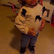 Delynn joined the competition — help win amazing prizes! bows, casual_clothing, chair, child, curly_hair, expression, floor, furniture, hair, home, indoor, jeans, person, room, sneakers, standing, sweater, toddler, toy_chair, young_child