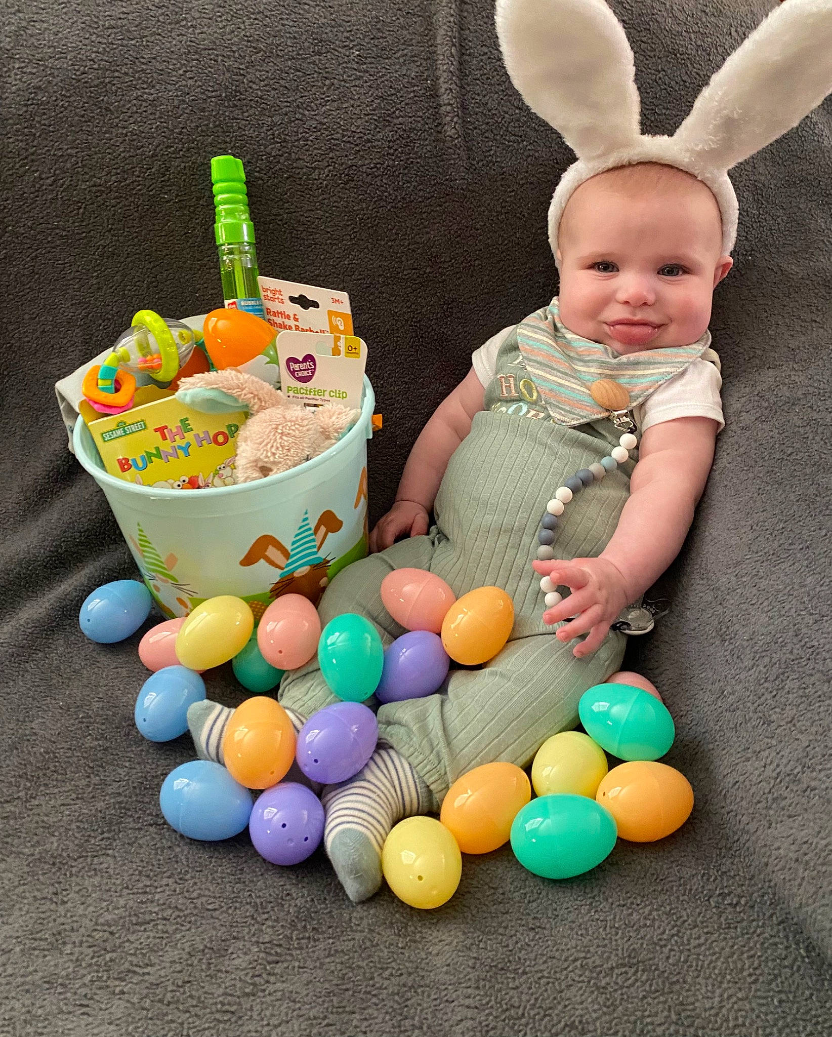 Coen is registered to the contest to win money with this photo: baby, baby_toddler_clothing, basket, bowl, child, easter, event, fawn, fun, happy, holiday, joy, local_food, party_supply, person, plastic, play, rabbit, storage_basket, sweetness