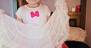 Ashley is registered to the contest to win money with this photo: bed, bedroom, blanket, child, clothing, cute, dress, frilly, girl, hair, happy, indoors, person, pillow, portrait, room, smile, toddler, white_dress, young