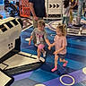 Ashley joined the competition — help win amazing prizes! adult, arcade, barbie_shirt, children, colorful, entertainment_center, family, geometric_floor, girls, glowing_lights, guardian, holding_hands, indoors, pink_shirt, play_area, play_equipment, preschooler, recreation, toddler, walking