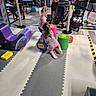 Ashley is registered to the contest to win money with this photo: children, colorful_blocks, crowd, daycare, family, foam_mats, gray_shirt, indoor, indoor_playground, letter_blocks, pink_shirt, pink_shorts, play_area, playing, recreation, rocking_chair, sitting, socks, stroller, toddler