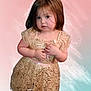 Ashley joined the competition — help win amazing prizes! child, toddler, girl, gold_dress, dress, portrait, pink_background, pastel, brown_hair, big_eyes, cute, standing, hands_clasped, expression, cheeks, skin, edited_background, princess, innocence, studio_style