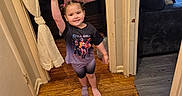 Ashley is registered to the contest to win money with this photo: air_conditioner, bedroom, braided_hair, child, couch, doorframe, girl, hallway, home, indoor, mismatched_socks, pigtails, pillow, shorts, smiling, toy_car, tshirt, waving, window, wooden_floor