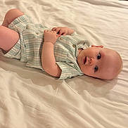 Archie joined the competition — help win amazing prizes! baby, infant, bed, bedding, clothing, cute, face, hand, laying_down, light, looking, one_person, person, portrait, skin, soft, striped, toddler, white, young_child