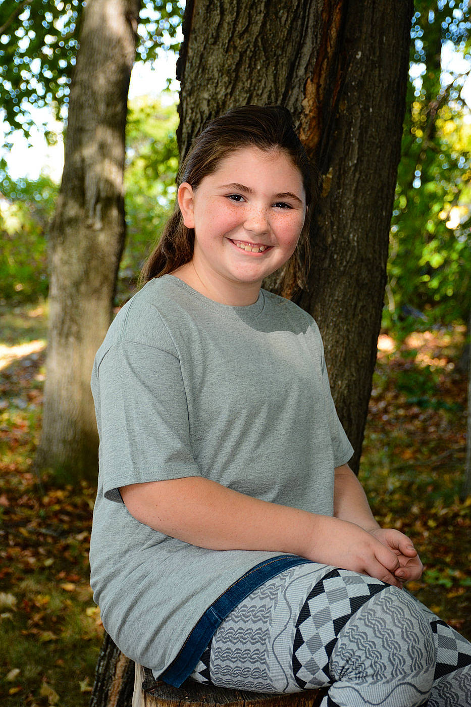 Kassidy is registered to the contest to win money with this photo: beauty, botany, child, eye, face, grass, green, head, joy, leaf, people, people_in_nature, person, photo_shoot, photograph, photography, plant, sitting, smile, tree