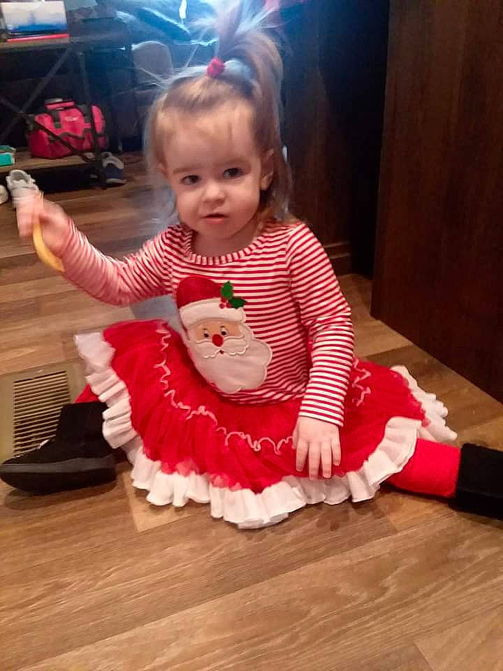 Ericka is registered to the contest to win money with this photo: baby, baby_toddler_clothing, child, dress, event, finger, floor, flooring, happy, hardwood, laminate_flooring, magenta, person, pink, sitting, skin, sleeve, sock, toddler, wood