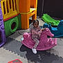 Retaan is registered to the contest to win money with this photo: toddler, child, indoor_play_area, rocking_horse, pink_toy, plaid_outfit, playground, colorful, plastic_toys, floor_mats, play_structure, girl, childrens_play, playroom, toy_horse, hair_pigtails, casual_clothing, cute, fun, smiling