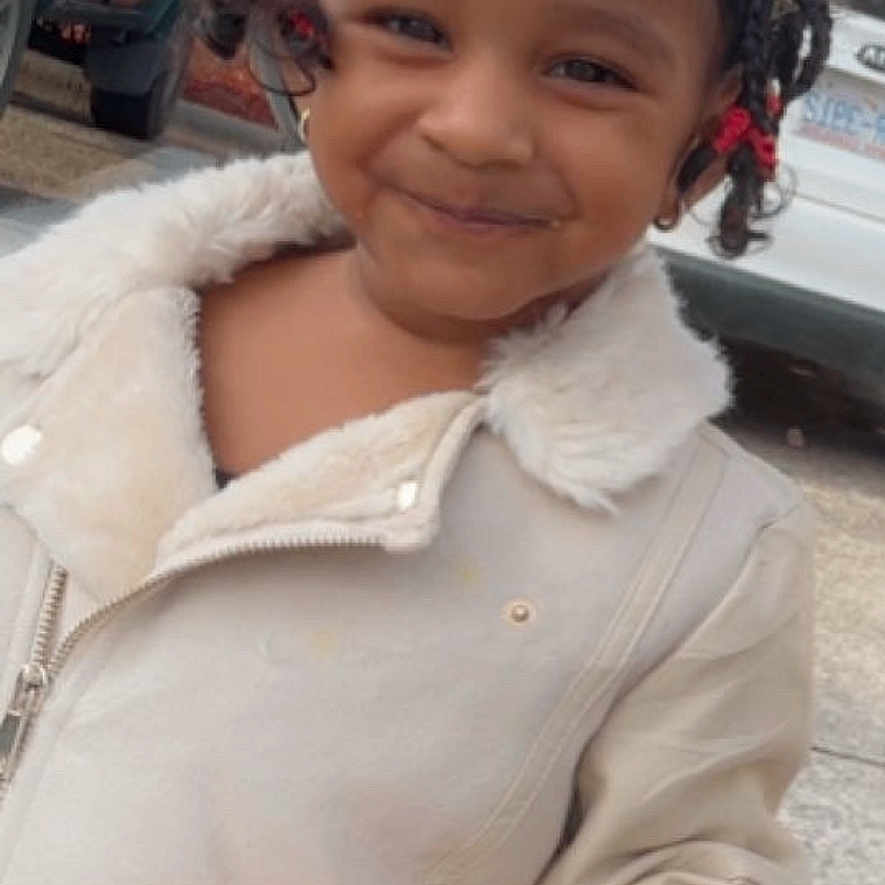 Retaan joined the competition — help win amazing prizes! braided_hair, car, casual_clothing, child, curly_hair, cute, daytime, food, happy, holding, jacket, outdoor, person, portrait, sandwich, smiling, street, urban, vehicle, young_child