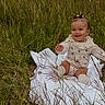 baby, blanket, child, clothing, cute, daylight, field, grass, greenery, hair_clips, happy, infant, nature, outdoor, portrait, sitting, smile, socks, wildflowers, young