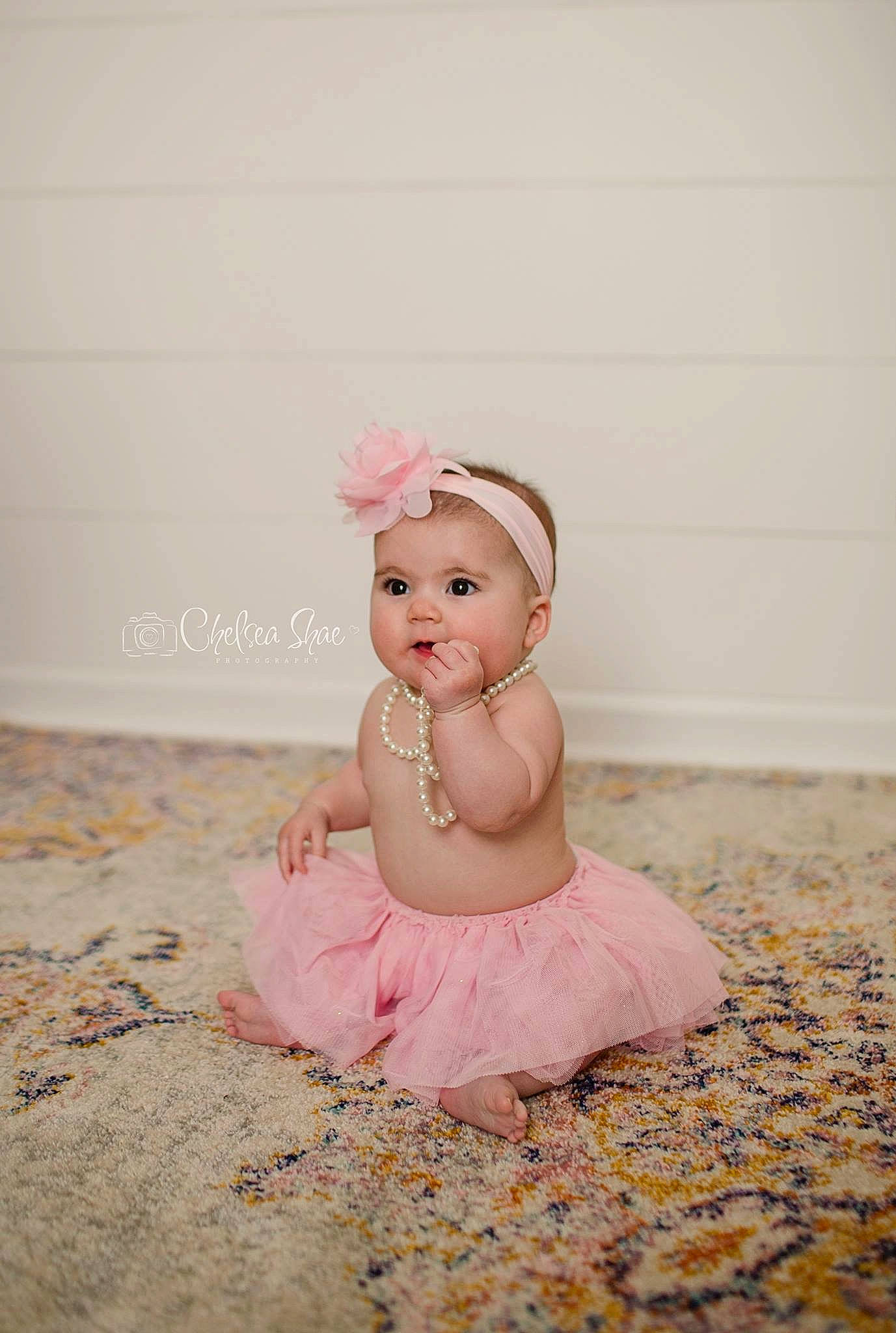 Anniston is registered to the contest to win money with this photo: baby, baby_toddler_clothing, ballet_dancer, ballet_tutu, child, costume, dress, fashion_accessory, footwear, hair_accessory, headgear, headpiece, person, photograph, photography, pink, shoe, sitting, skin, smile