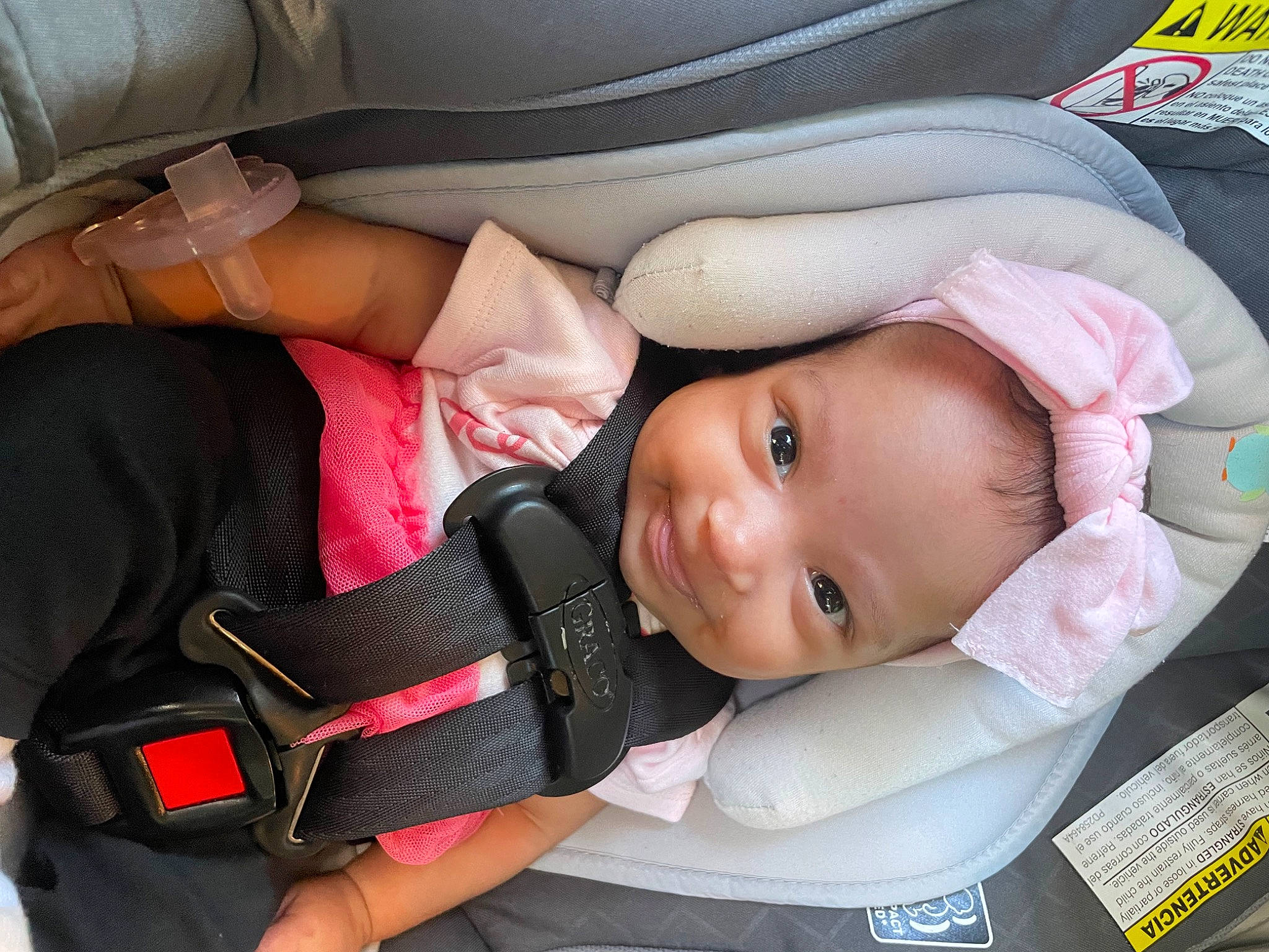 Kamora is registered to the contest to win money with this photo: auto_part, baby, baby_carriage, baby_in_car_seat, baby_products, baby_safety, baby_toddler_clothing, car_seat, carmine, cheek, child, comfort, eyelash, hat, nail, person, seat_belt, smile, toddler, white