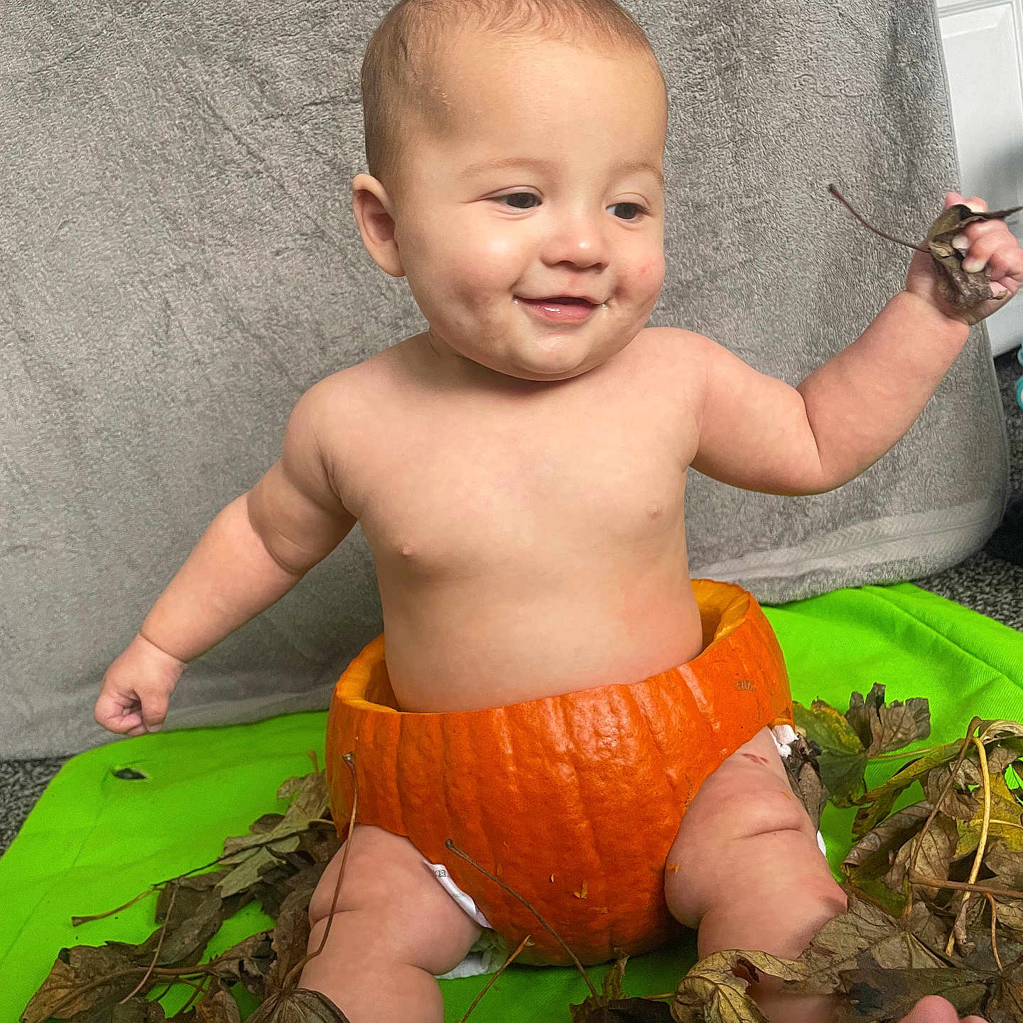 Shakeem is registered to the contest to win money with this photo: autumn_leaves, baby, bare_chest, child, cute, diaper, fall, green_background, happy, holiday, indoors, leaf, orange, playful, pumpkin, seasonal, sitting, skin, smiling, young