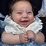 Lottie is registered to the contest to win money with this photo: baby, smile, happy, infant, clothing, blue_dress, white_ruffles, hands, face, cheeks, cute, joy, portrait, closeup, sitting, child, cute_expression, adorable, young, baby_clothes