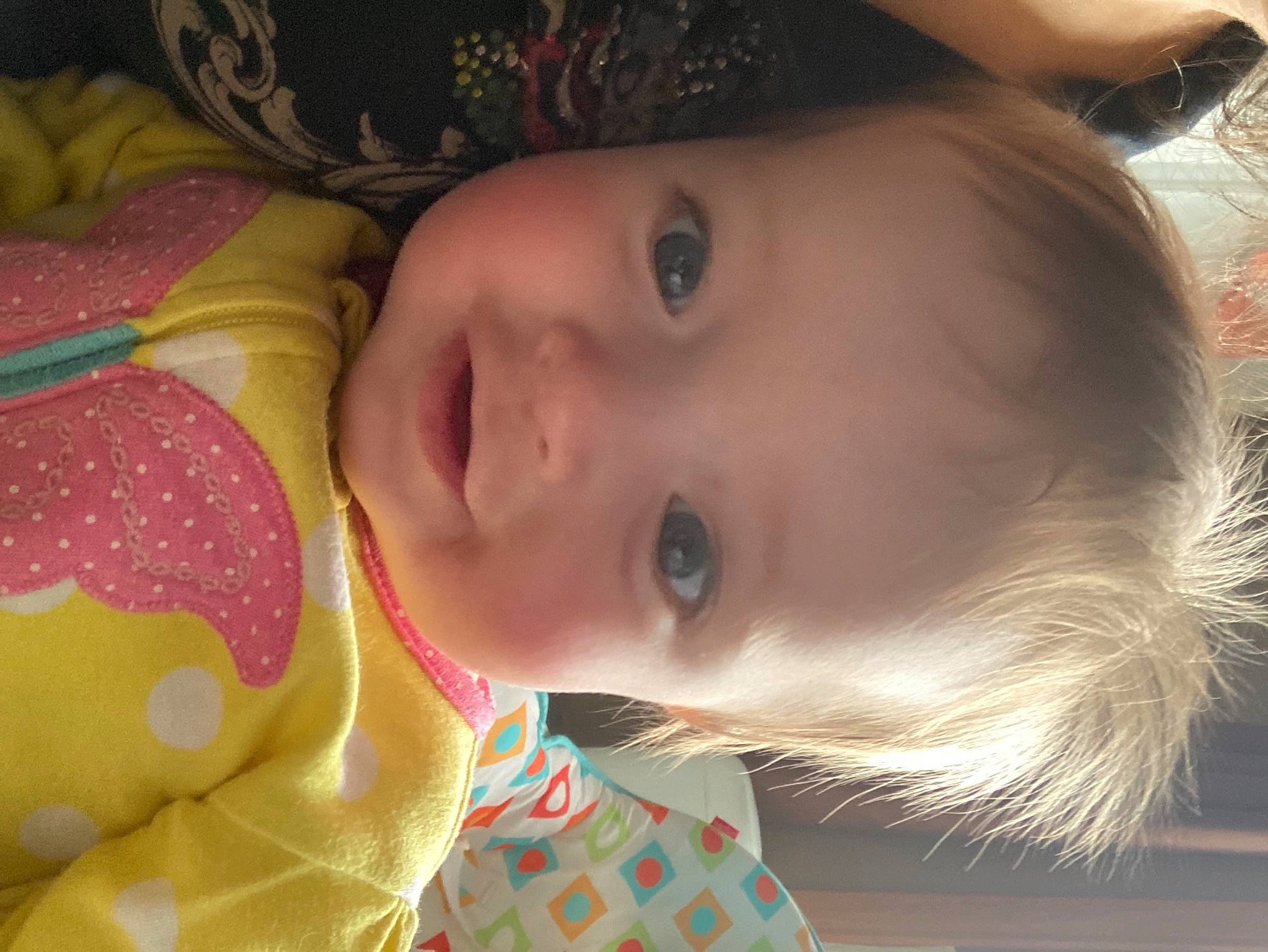 Sydney is registered to the contest to win money with this photo: baby_toddler_clothing, blond, cheek, child, chin, close_up, eyelash, fun, grass, happy, hat, iris, lip, mouth, nose, person, plant, skin, smile, toddler