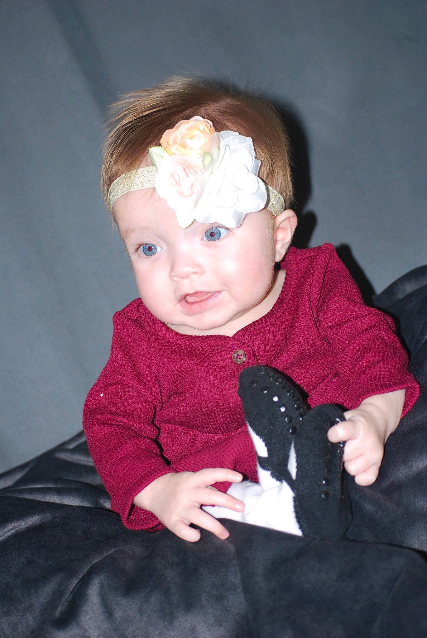 Sydney is registered to the contest to win money with this photo: arm, baby_toddler_clothing, black_hair, cheek, eye, finger, flash_photography, gesture, hand, happy, head, headgear, human_body, iris, lip, mouth, nose, person, skin, sleeve