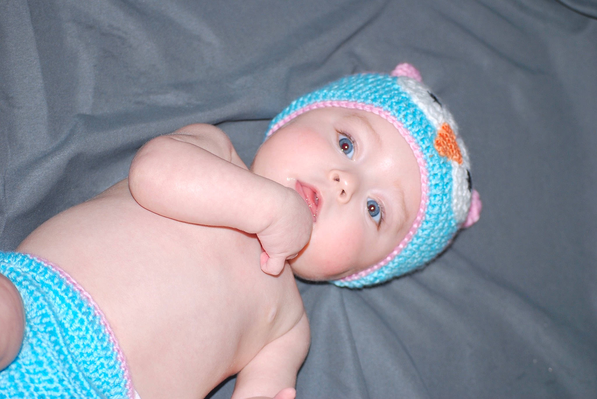 Shaelynn is registered to the contest to win money with this photo: azure, baby, baby_products, baby_toddler_clothing, chest, child, comfort, eye, hand, hat, headgear, headwear, human_body, human_leg, pattern, person, pink, skin, stomach, textile