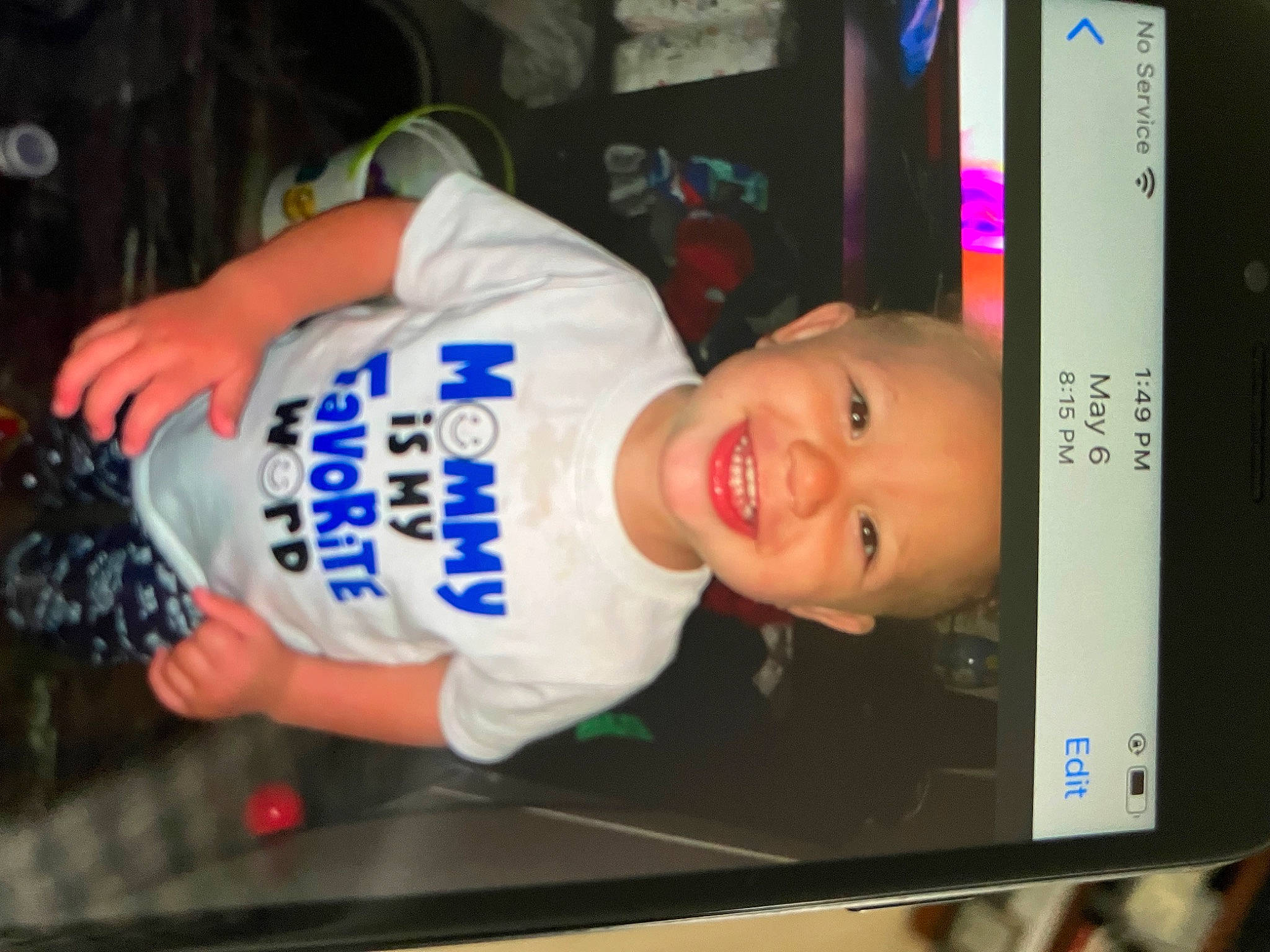 Jyaire is registered to the contest to win money with this photo: baby, baby_toddler_clothing, child, communication_device, display_device, electric_blue, face, flat_panel_display, fun, gadget, happy, joy, multimedia, output_device, person, photo_caption, room, sleeve, smile, t_shirt