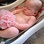 baby, sleeping, infant, baby_seat, pink, bath_sponge, skin, chubby, face, arm, leg, indoor, floor, tile_floor, furniture, peaceful, child, rest, relaxing, person