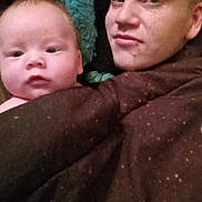 Randy joined the competition — help win amazing prizes! baby, adult, blanket, face, portrait, closeup, indoor, skin, person, cuddle, comfort, expression, head, young, parent, child, human, warmth, relaxation, bond