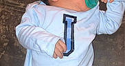 Jamison is registered to the contest to win money with this photo: baby, beverage, bodypart, clothing, coat, face, finger, furniture, hand, head, jacket, longsleeve, newborn, person, photography, portrait, shirt, sleeping, sleeve, t_shirt