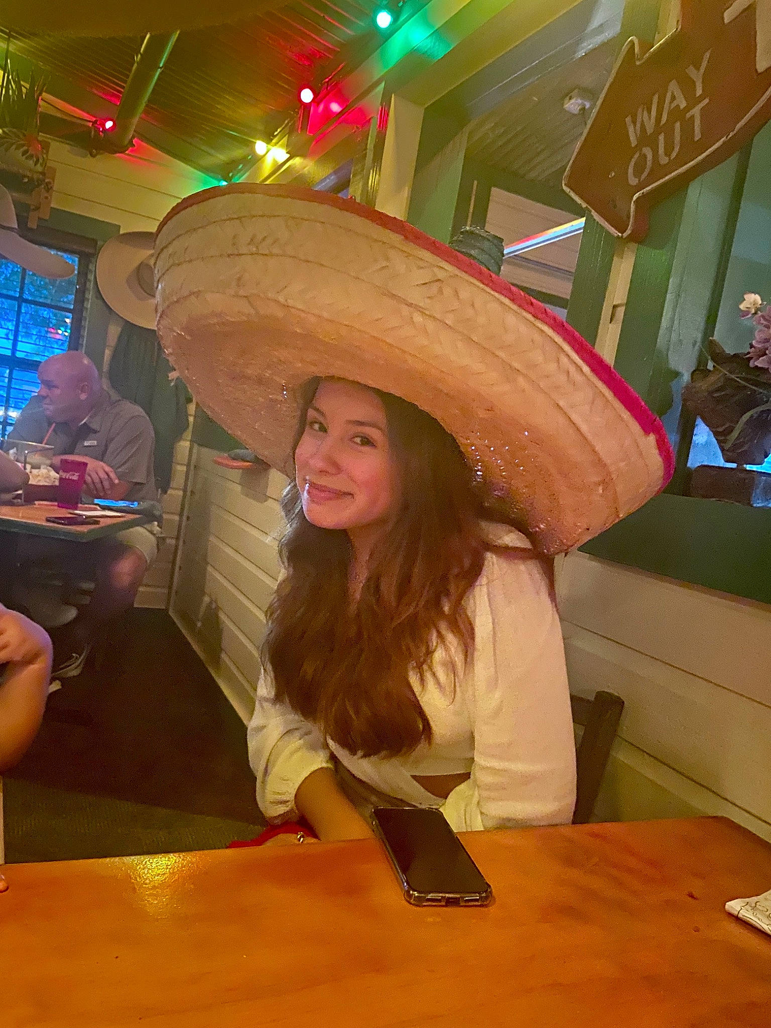 Sarah is registered to the contest to win money with this photo: chair, costume, costume_hat, event, fashion_accessory, flooring, fun, fur, happy, hat, joy, leisure, magenta, party, person, room, smile, sombrero, sun_hat, table