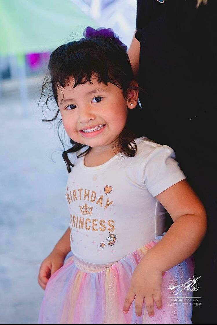 Estella is registered to the contest to win money with this photo: baby_toddler_clothing, blue, child, day_dress, event, fashion_accessory, flash_photography, fun, happy, joy, leisure, magenta, pattern, person, pink, play, purple, skin, sleeve, smile