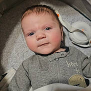 Chapel joined the competition — help win amazing prizes! baby, infant, child, blanket, onesie, dinosaur_patch, crib, playpen, baby_monitor, face, rosy_cheeks, eyes, clothing, sleepwear, indoors, soft_lighting, cute, young, lying_down, cozy