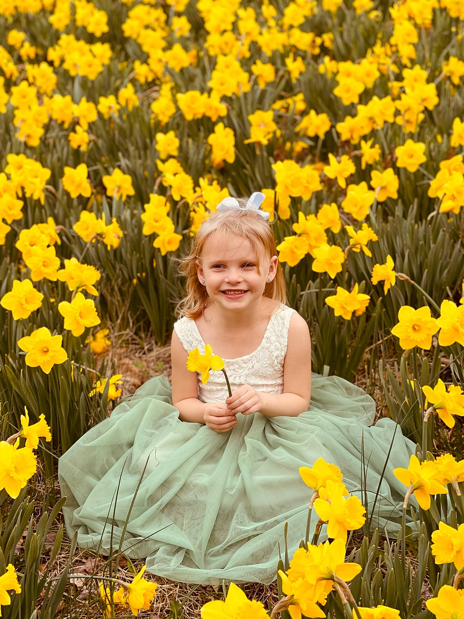 Allyson is registered to the contest to win money with this photo: botany, clothing, facial_expression, flower, flowering_plant, grass, groundcover, happy, joy, leaf, meadow, nature, organ, people, people_in_nature, person, petal, photograph, plant, smile