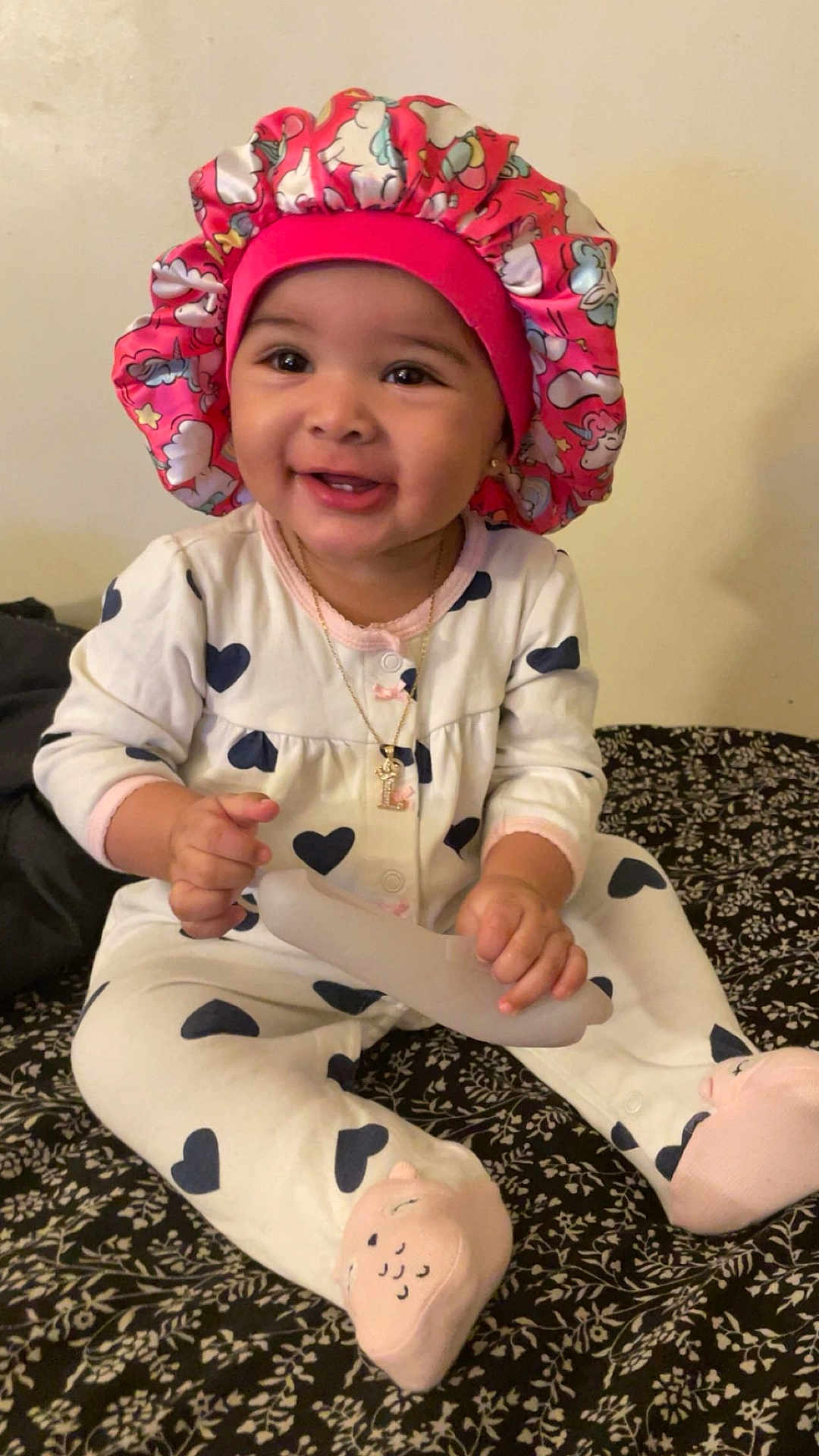 Lailahni is registered to the contest to win money with this photo: accessories, baby, bonnet, cap, clothing, coat, costume, face, happy, hat, head, jewelry, necklace, pajamas, pants, person, photography, portrait, sitting, smile