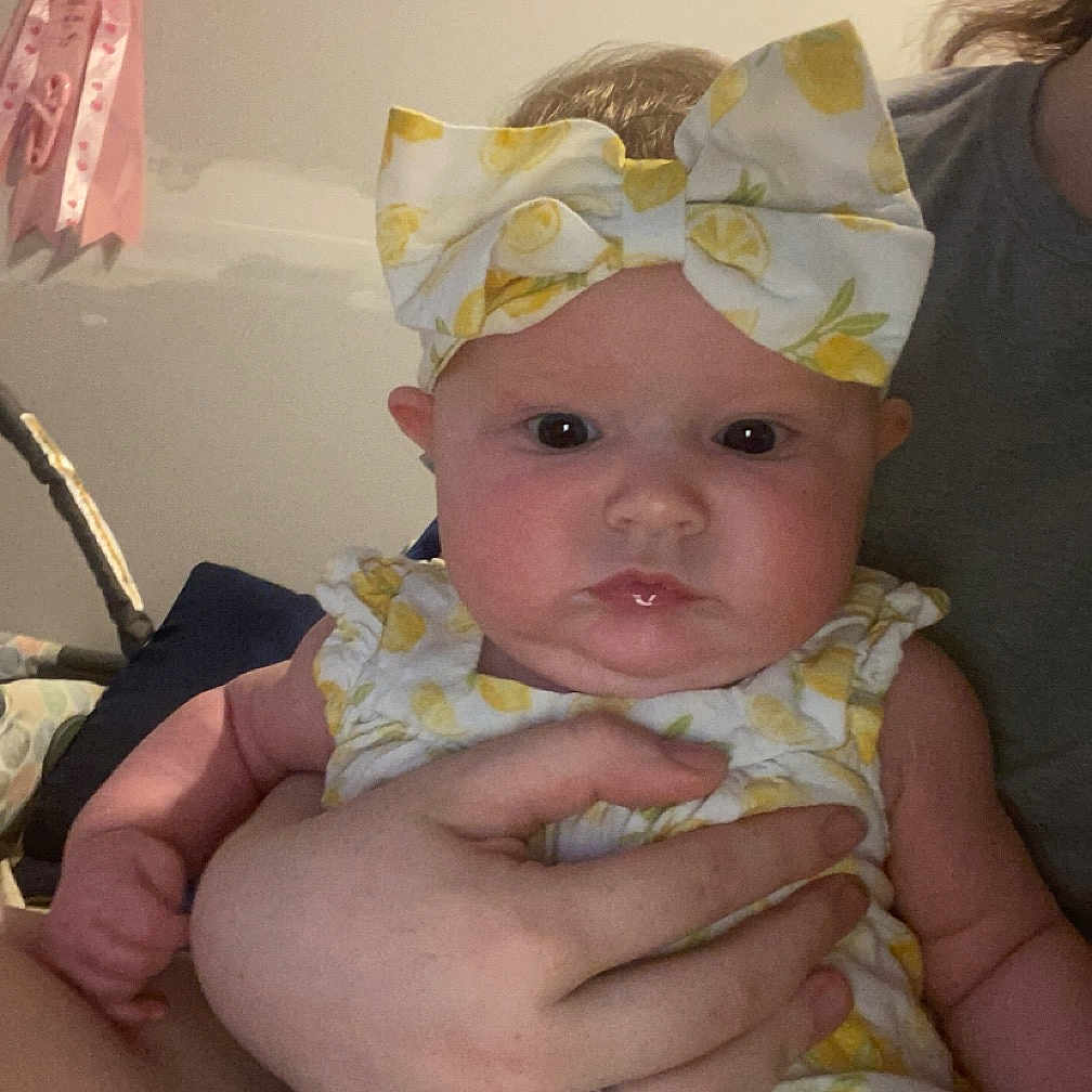 Sophia is registered to the contest to win money with this photo: accessories, baby, bracelet, clothing, dress, earring, face, formalwear, furniture, glasses, hat, head, jewelry, newborn, people, person, photography, portrait, quilt, ring