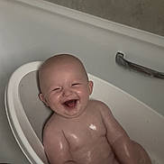 Mason is registered to the contest to win money with this photo: baby, bathtub, bath, bathroom, child, cute, face, happy, infant, laughing, light_reflection, metal_handle, person, plastic_seat, skin, smile, toddler, water, wet, young
